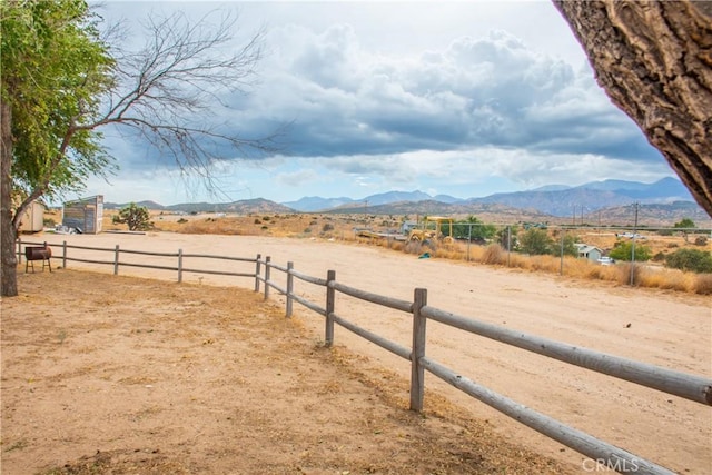 view of yard with a mountain view and a rural view