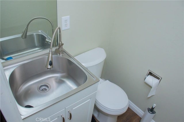 bathroom featuring vanity, hardwood / wood-style floors, and toilet