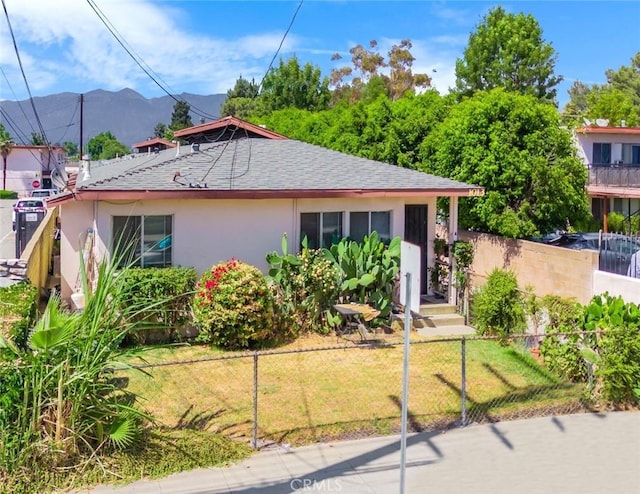 bungalow-style house featuring a mountain view and a front yard