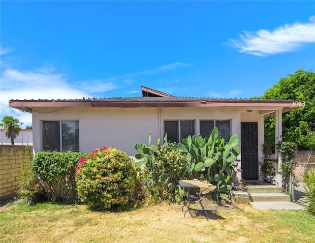 rear view of property featuring a yard