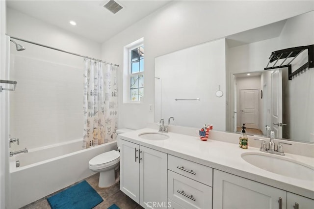 full bathroom featuring vanity, shower / tub combo, and toilet