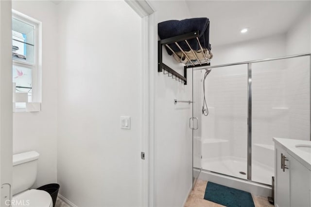 bathroom with vanity, toilet, and an enclosed shower