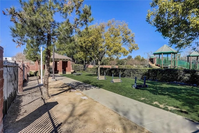 view of property's community with a playground and a yard