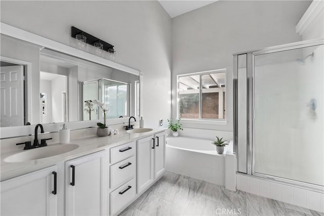 bathroom with vanity and separate shower and tub