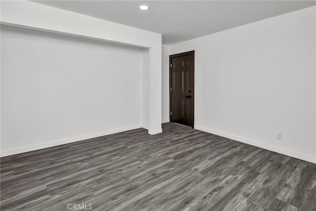 spare room featuring dark wood-type flooring