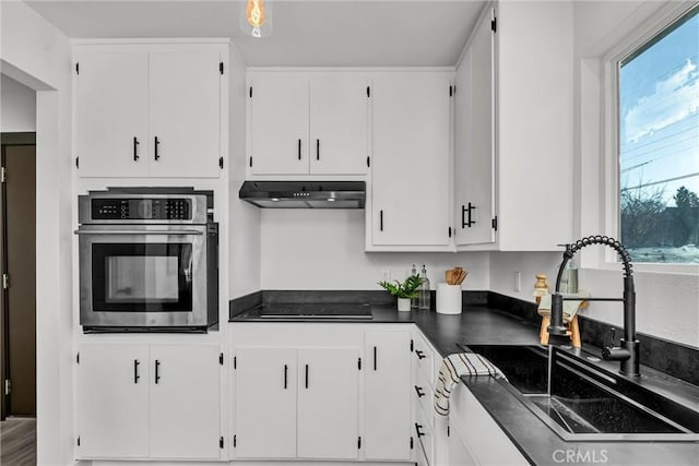 kitchen with white cabinetry, black electric stovetop, oven, and sink