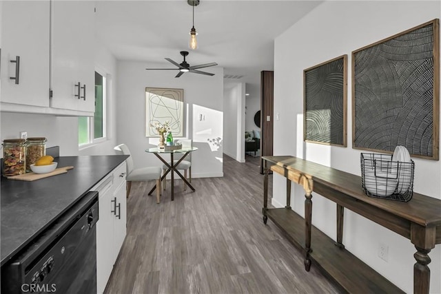 kitchen with white cabinetry, wood-type flooring, black dishwasher, pendant lighting, and ceiling fan