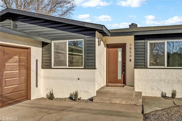 doorway to property featuring a garage