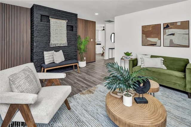 living room featuring wood-type flooring and ceiling fan