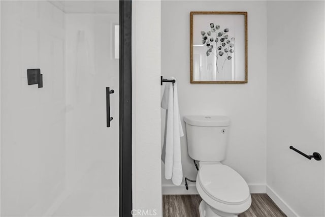 bathroom featuring hardwood / wood-style flooring and toilet