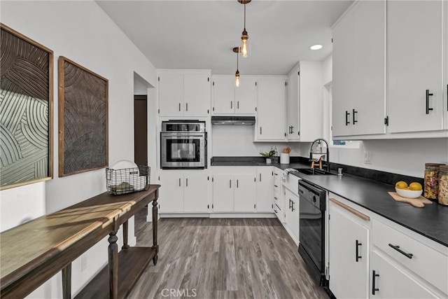 kitchen with pendant lighting, sink, wood-type flooring, black appliances, and white cabinets