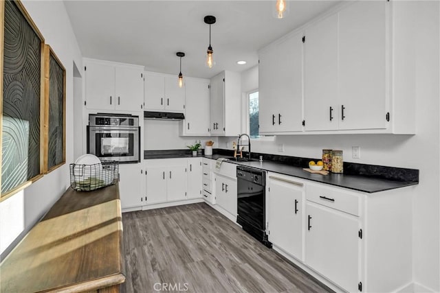 kitchen with sink, black dishwasher, stainless steel oven, and white cabinets