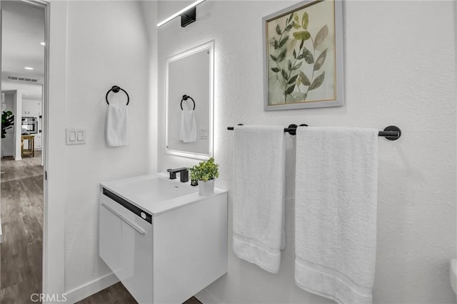 bathroom with vanity and wood-type flooring