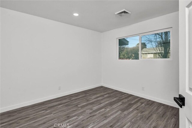 spare room with dark hardwood / wood-style flooring