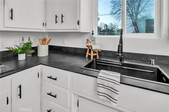 kitchen featuring sink and white cabinets