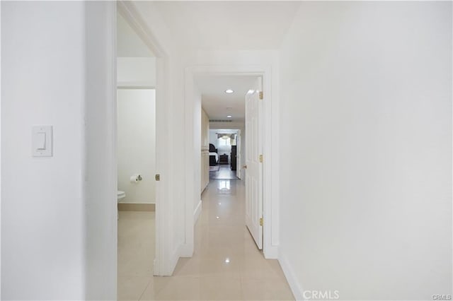 hall featuring light tile patterned floors