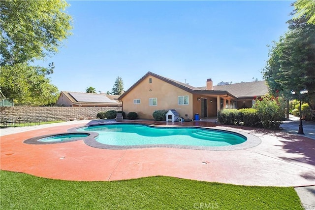 view of swimming pool featuring an in ground hot tub and a patio area