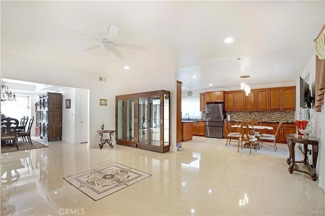 tiled living room featuring sink and ceiling fan