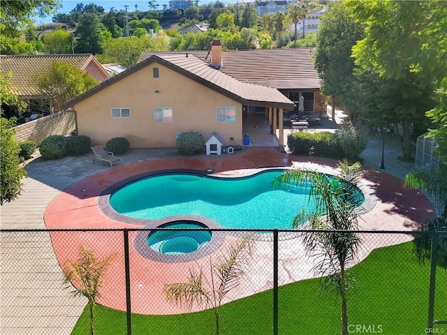 view of pool featuring a patio and an in ground hot tub