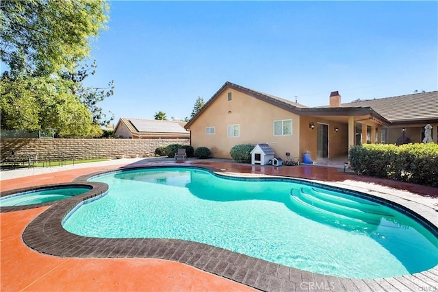 view of swimming pool with an in ground hot tub