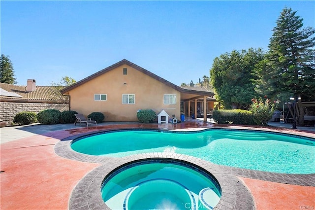 view of pool featuring an in ground hot tub and a patio