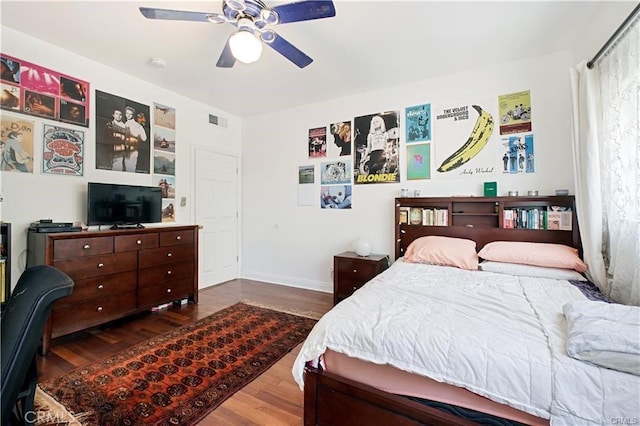 bedroom with ceiling fan and dark hardwood / wood-style floors