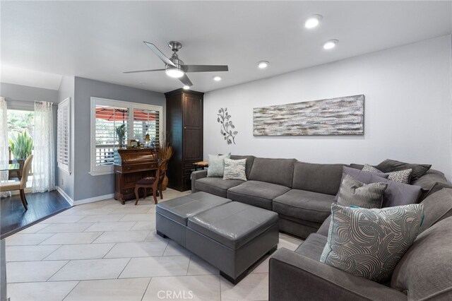 tiled living room with ceiling fan