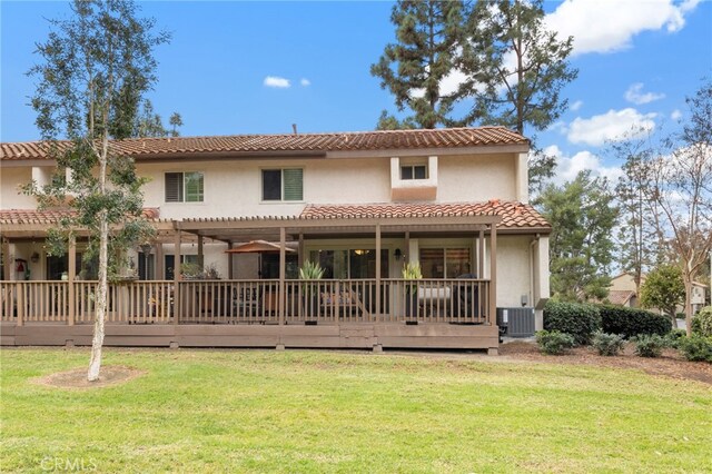 back of property featuring a pergola, a yard, central AC, and a deck