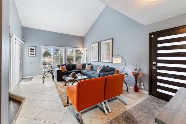 living room with high vaulted ceiling and light tile patterned flooring