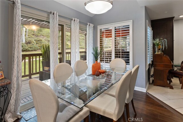 dining space with dark hardwood / wood-style floors