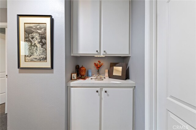 bar with white cabinetry