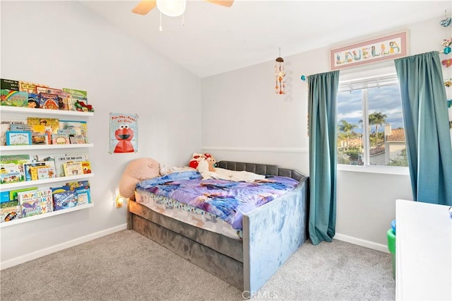 bedroom with vaulted ceiling, light colored carpet, and ceiling fan