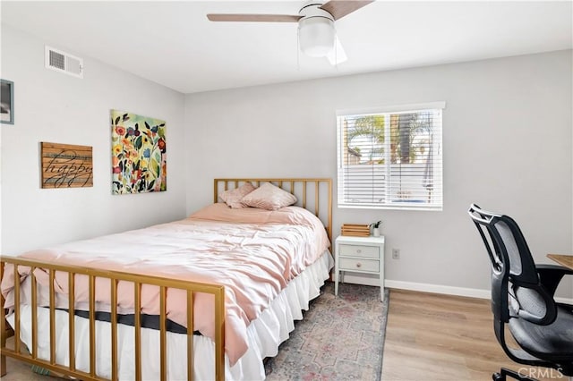 bedroom with ceiling fan and hardwood / wood-style floors