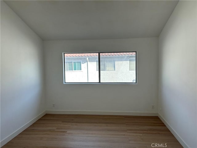 empty room with light hardwood / wood-style flooring