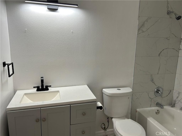 full bathroom featuring vanity, tiled shower / bath combo, and toilet