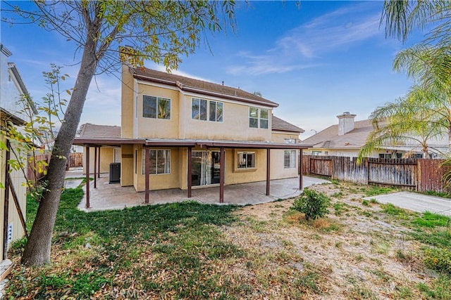 rear view of house with a patio, a lawn, and central air condition unit