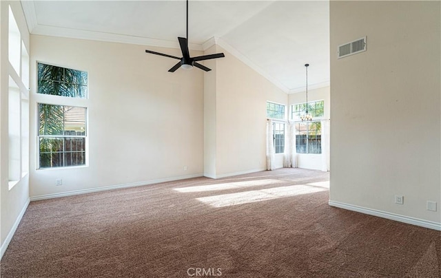 unfurnished room with ceiling fan with notable chandelier, ornamental molding, high vaulted ceiling, and carpet flooring