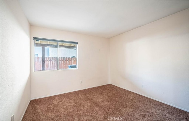 unfurnished room featuring carpet