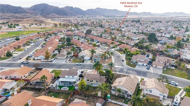 birds eye view of property with a mountain view