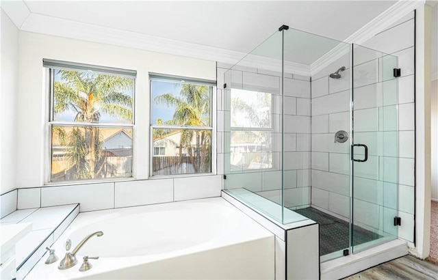 bathroom with crown molding, wood-type flooring, and shower with separate bathtub