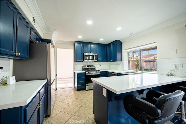 kitchen featuring sink, stainless steel appliances, kitchen peninsula, and blue cabinetry