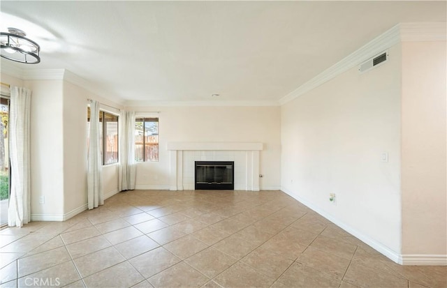 unfurnished living room featuring crown molding, light tile patterned floors, and a fireplace