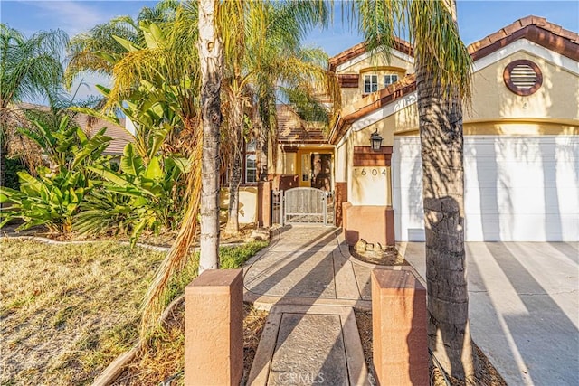 mediterranean / spanish-style home with a garage