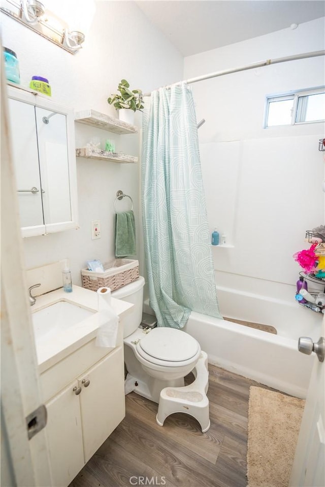 full bathroom featuring vanity, hardwood / wood-style flooring, toilet, and shower / tub combo with curtain