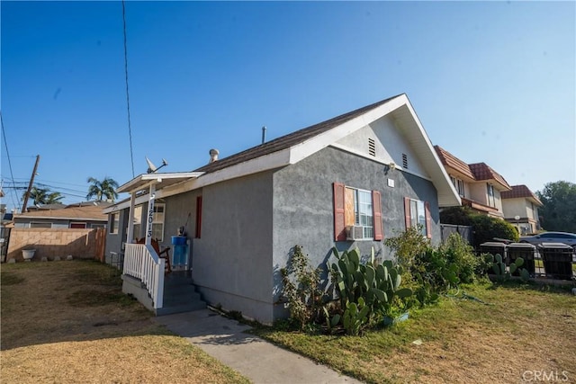 view of side of home featuring a lawn