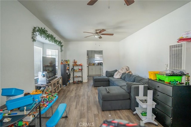 living room featuring hardwood / wood-style flooring and ceiling fan