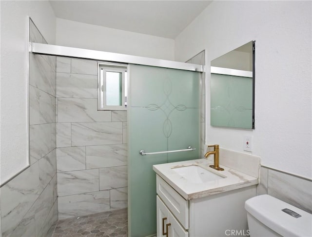 bathroom with vanity, toilet, and an enclosed shower