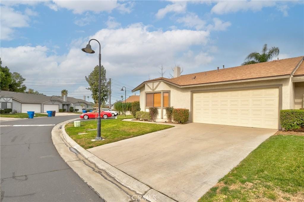 view of front of home with a garage and a front yard