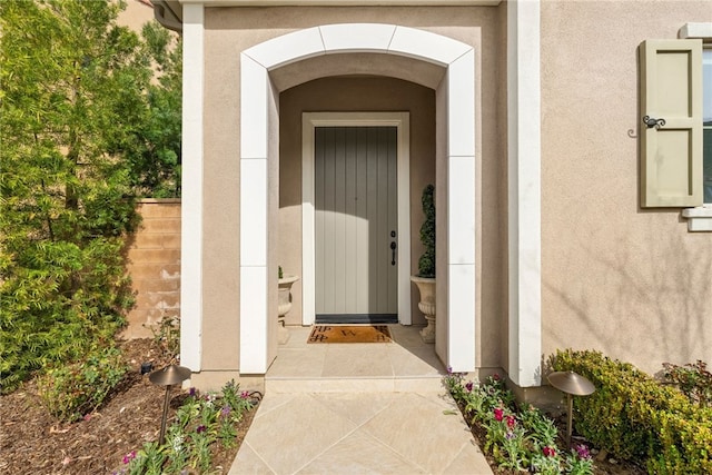 doorway to property with stucco siding