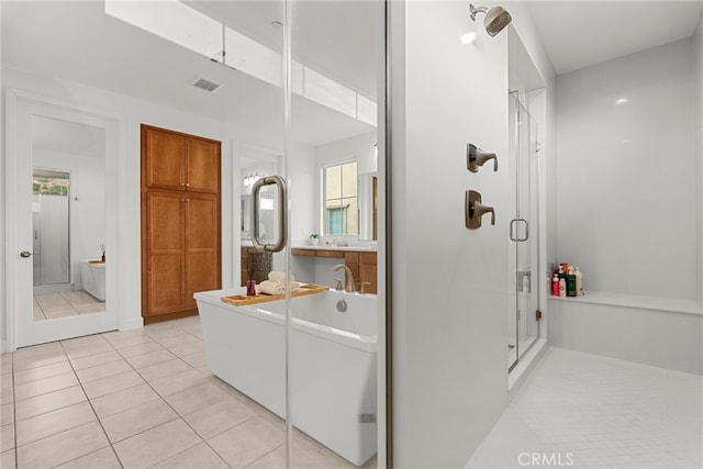 full bath with a soaking tub, tile patterned flooring, visible vents, and a shower stall